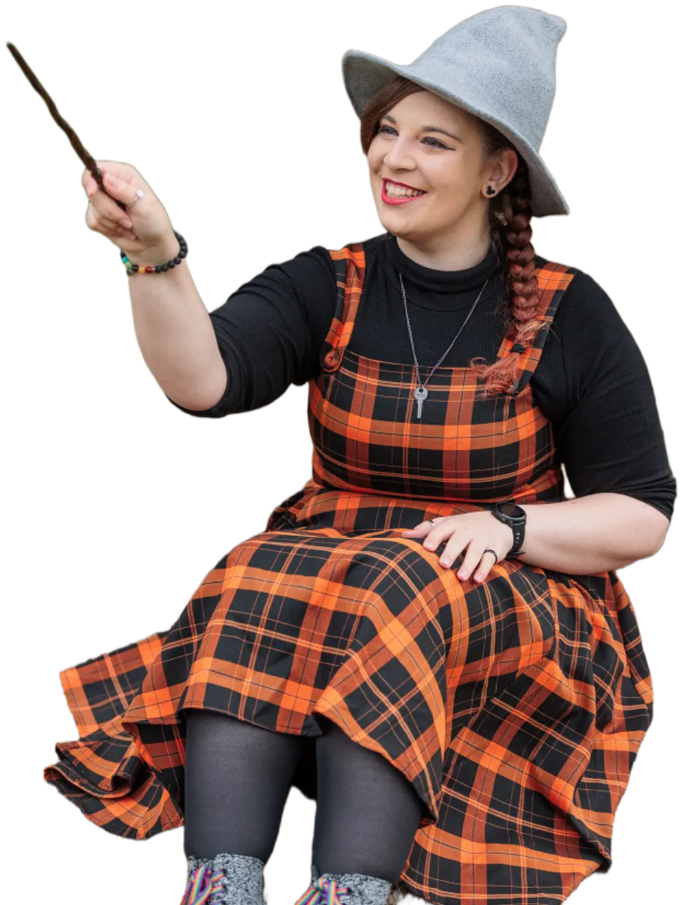 worktop with two people working at multiple laptops with cups of coffee, cables, phones and headphones